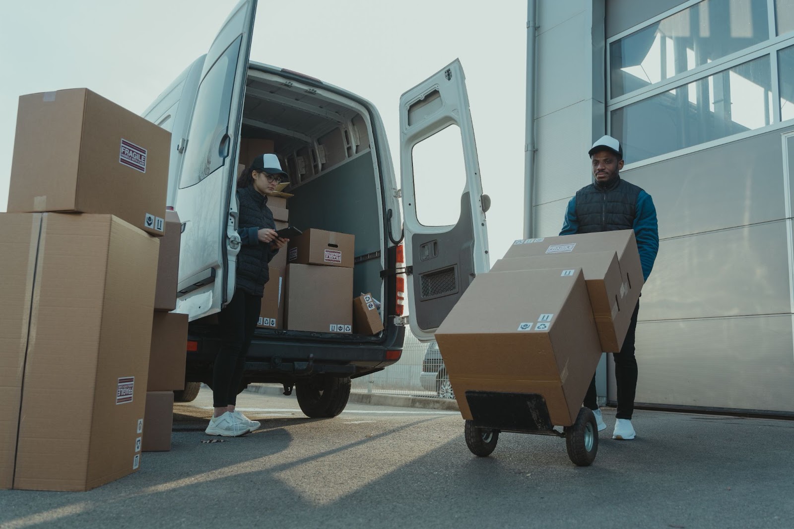 delivery drivers collecting brown boxes for shipment