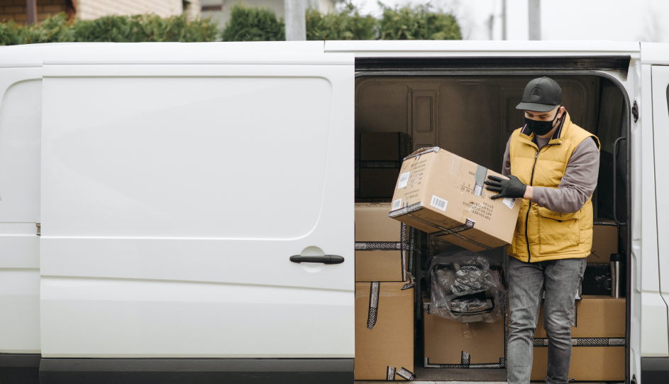 Last mile delivery driver takes a package from the delivery van